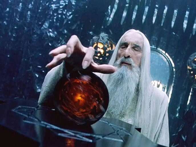 Saruman The White with his hand over his orb.